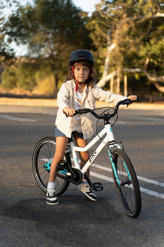 Child sitting on a Biky kids bike with visible front and rear tires